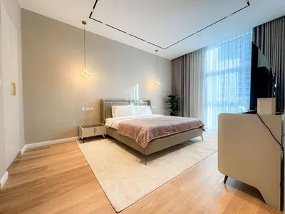 a bedroom with a bed and a large window at Exquisite 1BR Hidden Gem - Oceana Residences in Dubai