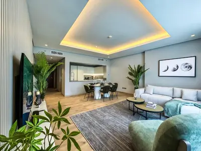 a living room with a couch and a table at Majestic 2BR Haven with Burj Khalifa View in Dubai