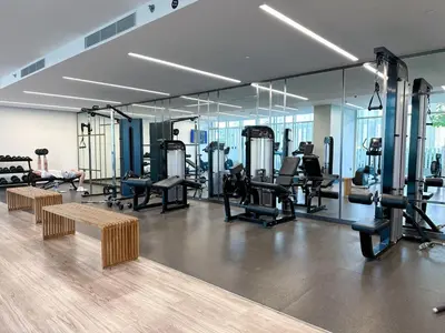 a gym with several treadmills and mirrors at Vibrant 1BR Apartment with Marina & Ocean View in Dubai