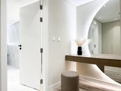 a bathroom with a mirror and a stool at Charming Ocean View 1BR Apartment at 5 Star Resort in Dubai
