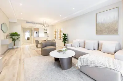 a living room with a couch and a table at Charming Ocean View 1BR Apartment at 5 Star Resort in Dubai