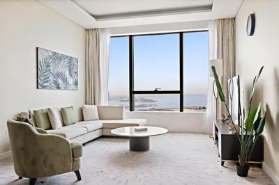 a living room with a couch and a table at Stonetree - Full Sea View - Luxury Tower with 5 Star Facilities in Dubai