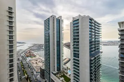 an aerial view of two tall buildings next to the ocean at Goldbest - 2bdr Marina view in Dubai