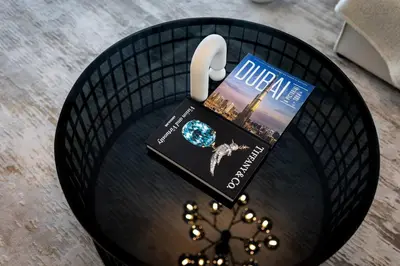 a table with a book and headphones on it at Goldbest - 2bdr Marina view in Dubai