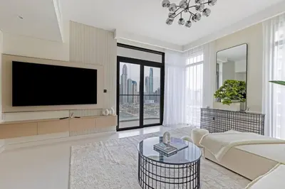 a living room with a tv and a couch at Goldbest - 2bdr Marina view in Dubai