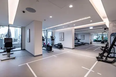 a gym with treadmills and ellipticals in a building at Goldbest - 2bdr Marina view in Dubai