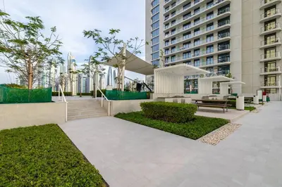 a courtyard with a bench and a building at Goldbest - 2bdr Marina view in Dubai