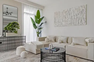 a white living room with a couch and a table at Goldbest - 2bdr Marina view in Dubai