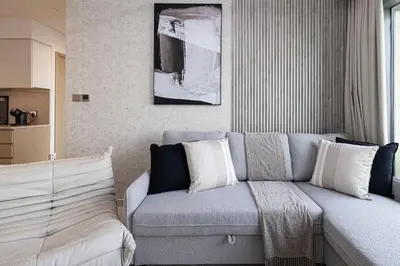 a living room with a gray couch at SmartStay at Burj Royale - Unique Downtown Dubai City Views - Brand New Luxury Apartments in Dubai