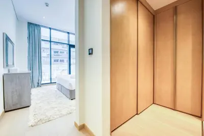 a bedroom with a bed and a large window at RH- Elevated Living, Modern 1BR Oasis at RP Heights walk away to Dubai Mall in Dubai