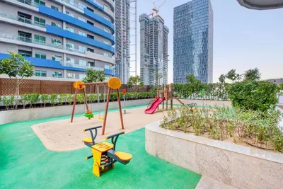 a playground with slides and swings in the water in a city at RH- Elevated Living, Modern 1BR Oasis at RP Heights walk away to Dubai Mall in Dubai