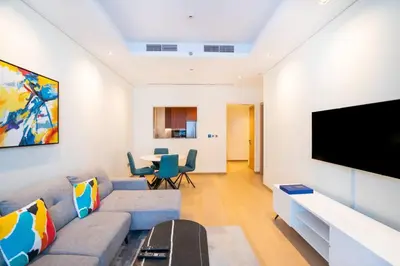 a living room with a couch and a flat screen tv at RH - Burj Khalifa View, 01 BR Bliss at RP Heights, walk away to Dubai Mall in Dubai