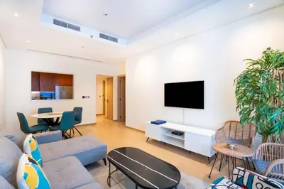 a living room with a couch and a tv at RH - Burj Khalifa View, 01 BR Bliss at RP Heights, walk away to Dubai Mall in Dubai
