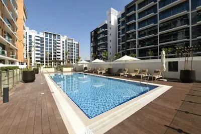a swimming pool in the middle of a building at Stylish and Modern Studio at Azizi Riviera - Dubai in Dubai