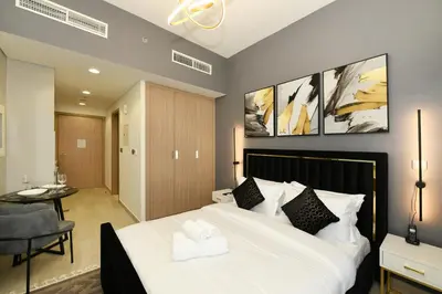 a bedroom with a large white bed in a room at Stylish and Modern Studio at Azizi Riviera - Dubai in Dubai