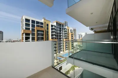 an apartment balcony with a view of buildings at Stylish and Modern Studio at Azizi Riviera - Dubai in Dubai