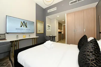 a hotel room with a bed with a tv on the wall at Stylish and Modern Studio at Azizi Riviera - Dubai in Dubai