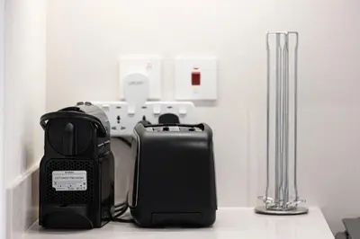 a appliance sitting on a counter next to a blender at Bright 2BR with Pool & Creek Views in Dubai