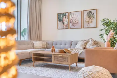 a living room with a couch and a coffee table at Luxury 3BHK, Burj Khalifa & Dancing fountain view in Dubai