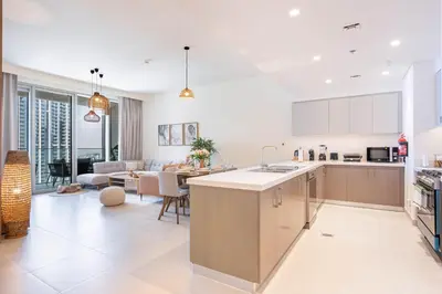 an open kitchen and living room with a couch at Luxury 3BHK, Burj Khalifa & Dancing fountain view in Dubai