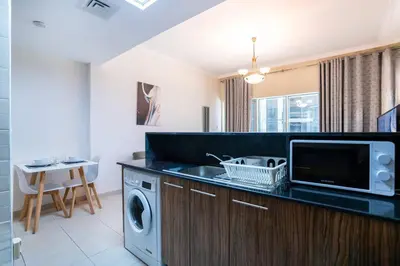 a kitchen with a sink and a washing machine at RH - Spacious studio, near Dubai Mall, Downtown in Dubai