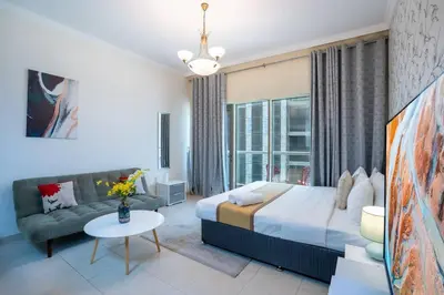 a bedroom with a large bed and a couch at RH - Spacious studio, near Dubai Mall, Downtown in Dubai