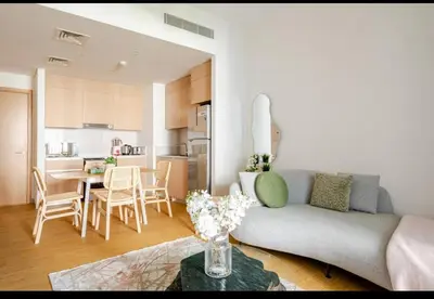 a living room with a couch and a table at Exquisite 1-Bedroom with Pool Scenery in Dubai Creek Harbour in Dubai