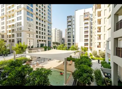 a large white pavilion in a city with tall buildings at Exquisite 1-Bedroom with Pool Scenery in Dubai Creek Harbour in Dubai
