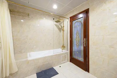 a bathroom with a bath tub and a shower at Luxury 4-Bedroom with Maids Room, Marina and Ain Dubai Views in Dubai