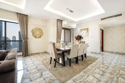 a dining room with a table and chairs at Luxury 4-Bedroom with Maids Room, Marina and Ain Dubai Views in Dubai