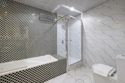 a bathroom with a shower and a toilet and a sink at Luxury 4-Bedroom with Maids Room, Marina and Ain Dubai Views in Dubai