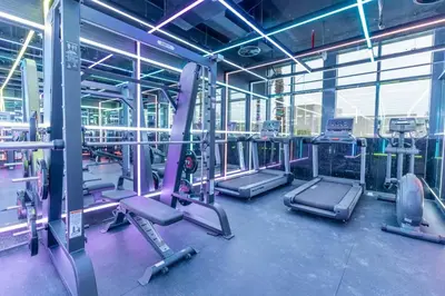 a gym with rows of treadmills and machines at Holiday Studio in JVC 2408, Dubai in Dubai