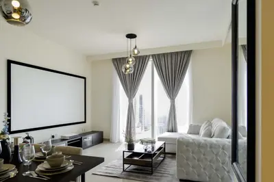 a living room with a couch and a large window at Sleeps 8 Private Cinema World Island Views in Dubai