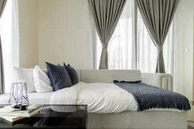 a bedroom with a bed and a glass table at Sleeps 8 Private Cinema World Island Views in Dubai