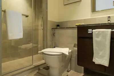 a bathroom with a toilet and a shower at Sleeps 8 Private Cinema World Island Views in Dubai