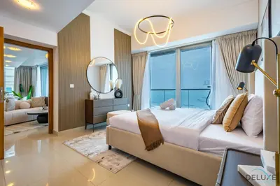 a bedroom with a large bed and a mirror at Luxury 3BR in Ocean Heights, Dubai Marina by Deluxe Holiday Homes in Dubai