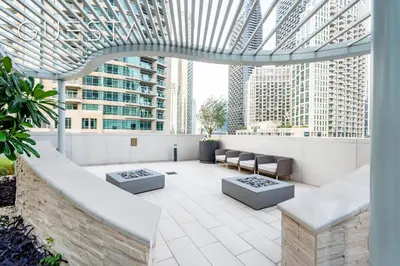 a rooftop patio with a view of skyscrapers at Forte Tower - Dubai Fountain View, Downtown Dubai in Dubai