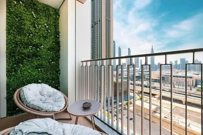 a balcony with a bed and a view of a city at Burj Khalifa View & Dubai Mall Connection in Dubai