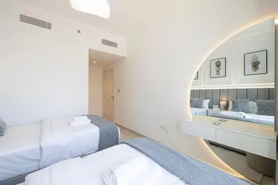 a bedroom with two beds and a mirror at Burj Khalifa View & Dubai Mall Connection in Dubai
