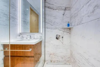 a bathroom with a shower with a sink and a mirror at RH - Beautiful & Spacious furnished 01 BR, Walk away from Dubai Mall in Dubai