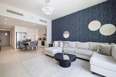 a living room with a couch and a table at FULL Burj Khalifa view 2BR with Dubai Mall connection in Downtown in Dubai