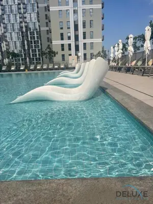 a white slide in a pool of water at Enchanting 1BR Apartment in Socio Tower, Dubai Hills Estate by Deluxe Holiday Homes in Dubai