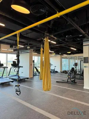 a gym with a hammock and exercise equipment at Enchanting 1BR Apartment in Socio Tower, Dubai Hills Estate by Deluxe Holiday Homes in Dubai
