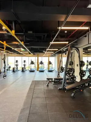 a gym with treadmills and machines in a room at Enchanting 1BR Apartment in Socio Tower, Dubai Hills Estate by Deluxe Holiday Homes in Dubai