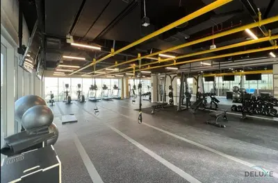 a gym with a lot of treadmills and machines at Enchanting 1BR Apartment in Socio Tower, Dubai Hills Estate by Deluxe Holiday Homes in Dubai