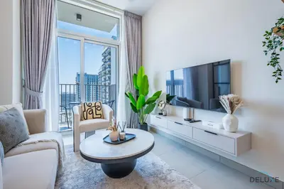 a living room with a tv and a large window at Enchanting 1BR Apartment in Socio Tower, Dubai Hills Estate by Deluxe Holiday Homes in Dubai