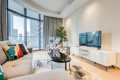 a living room with a couch and a tv at RH - Spacious chic apartment, Next to Dubai Mall in Dubai