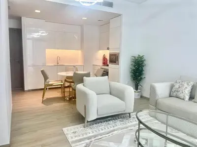 a living room with a couch and a table at High Floor, 1 Bedroom in Palace Residence in Dubai
