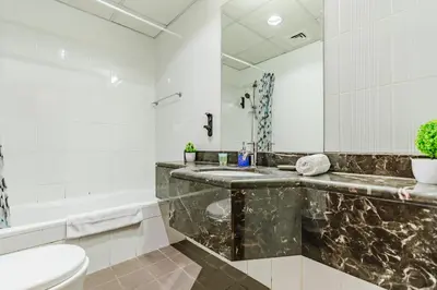 a bathroom with a sink and a toilet and a tub at RH - Best location, 01 BR Spacious, walk to burj in Dubai