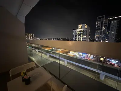 a room with a view of a city at night at Dubai 7 in Dubai